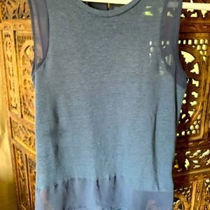 Cute top and be worn dressed up or down. Has some sheer edges and back 1/2 sheer
